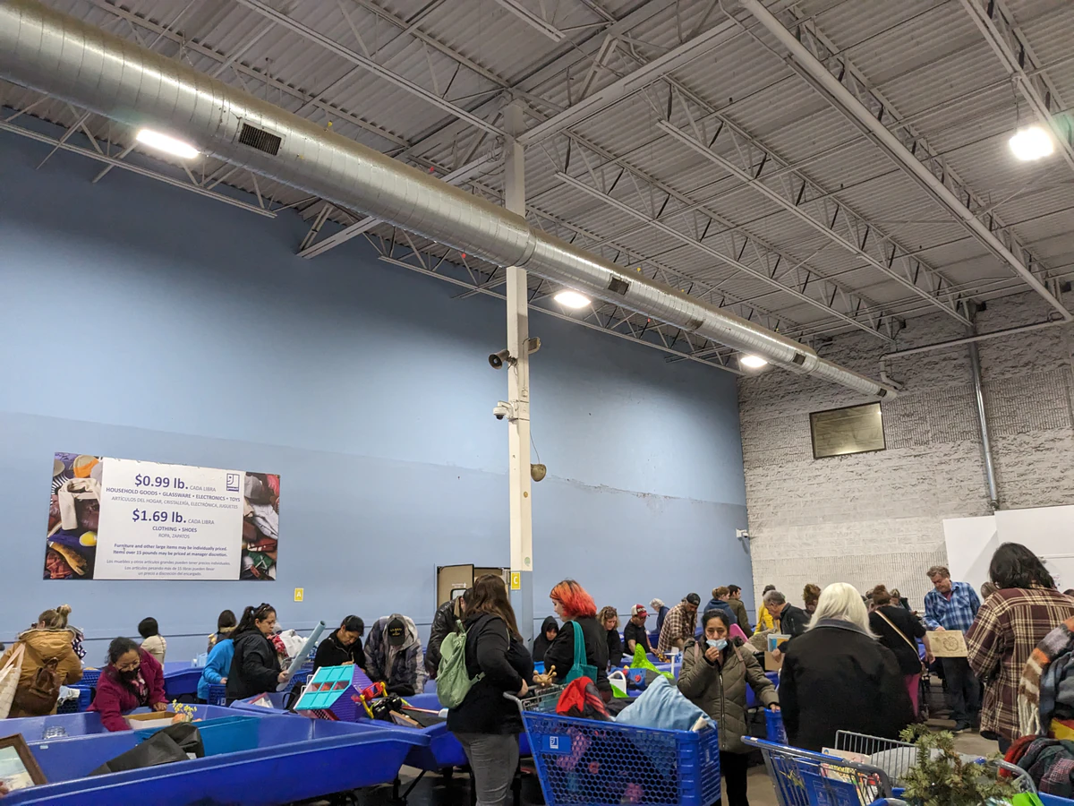 Goodwill Outlet Center in Grandville, Michigan, highlighting organized racks of clothing near the checkout area.