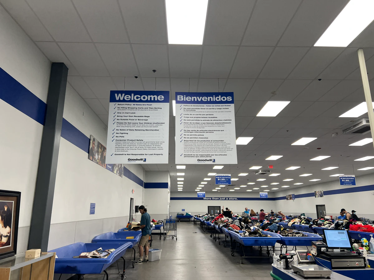 Goodwill Outlet Center in Middletown, Pennsylvania, featuring shoppers searching through bulk textile containers.
