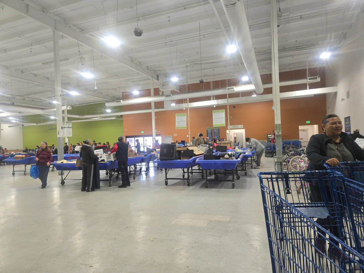 Goodwill Outlet in Denver, Colorado, a Goodwill outlet store featuring shoppers searching through bulk textile containers.