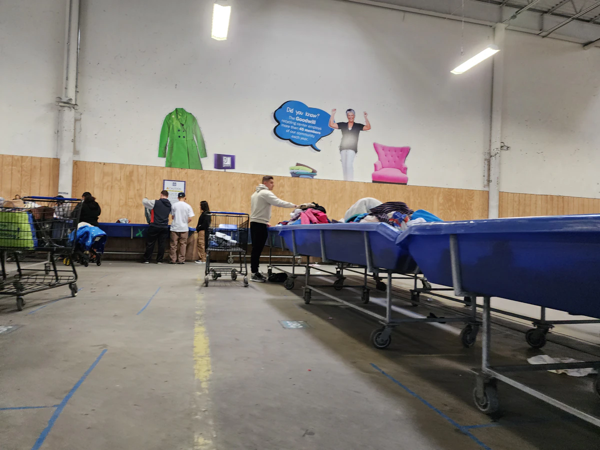 Goodwill Outlet in New Castle, Delaware, highlighting organized racks of clothing near the checkout area.