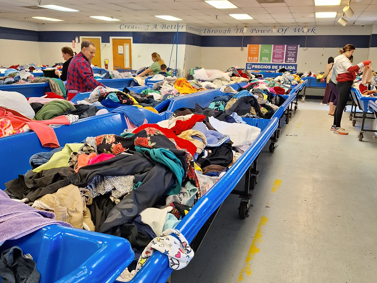 Goodwill Outlet in Savannah, Georgia, a Goodwill outlet store featuring shoppers searching through bulk textile containers.