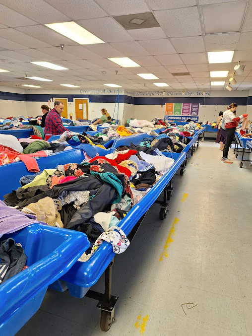 Goodwill Outlet in Savannah, Georgia, highlighting organized racks of clothing near the checkout area.