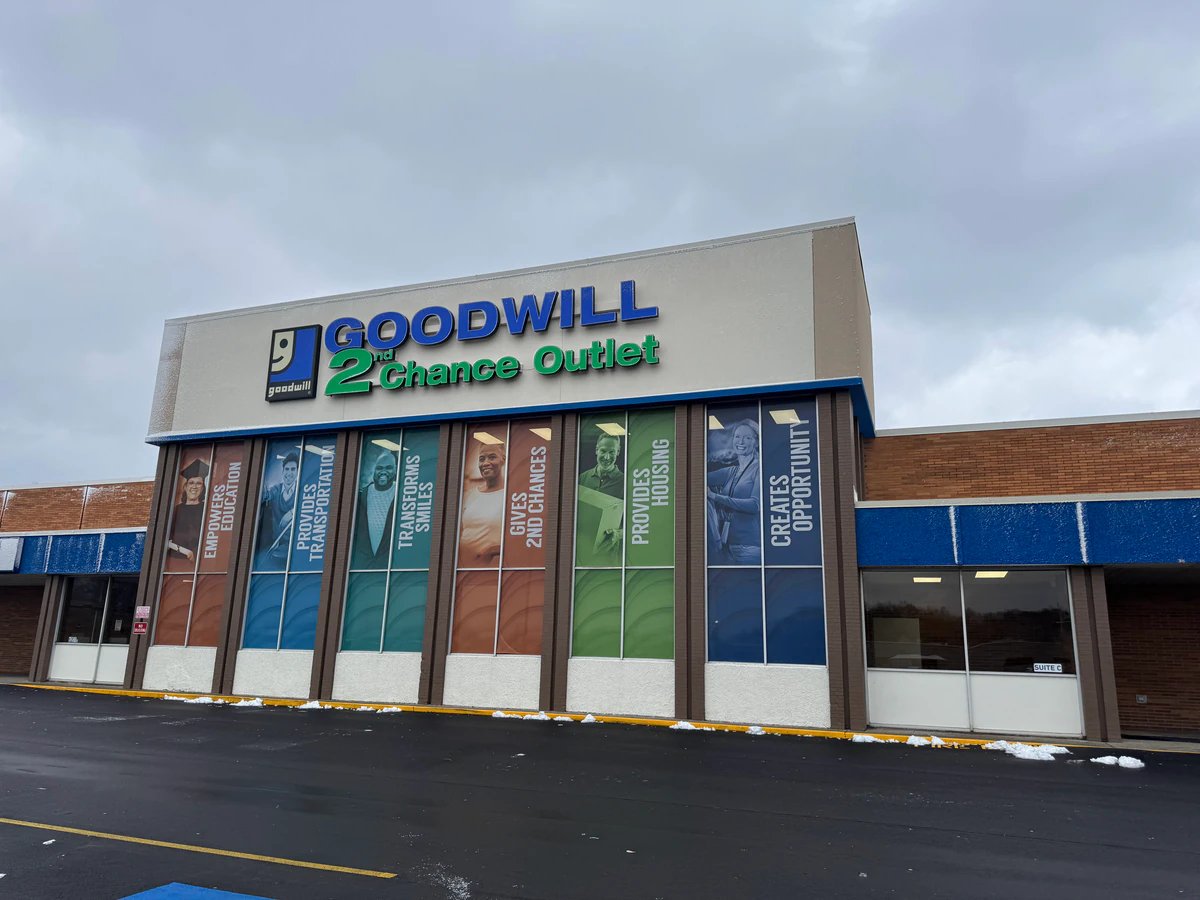 Goodwill Outlet in Louisville, Kentucky, showing blue rolling bins filled with discounted merchandise.