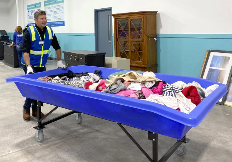 Goodwill Outlet in Muskegon, Michigan, a Goodwill outlet store showing blue rolling bins filled with discounted merchandise.