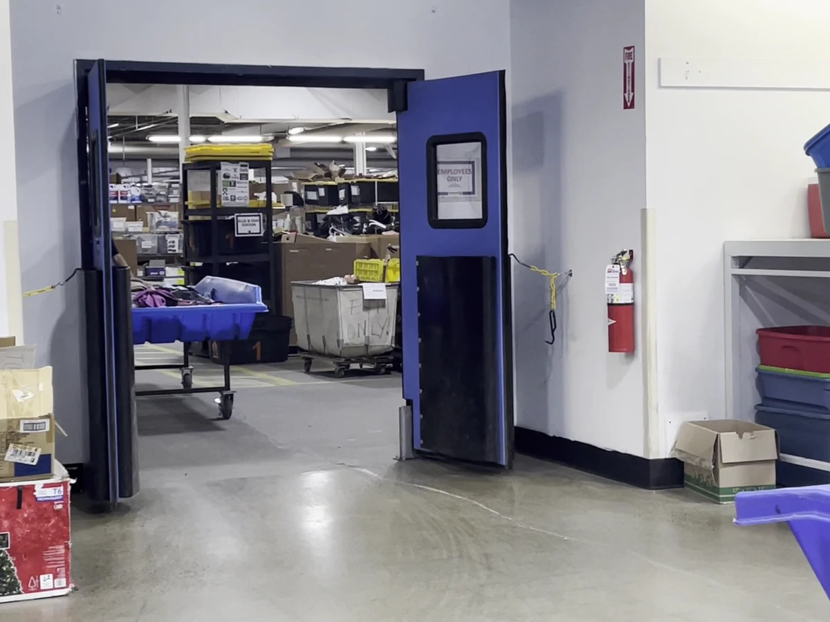 Goodwill Outlet in Akron, Ohio, a Goodwill outlet store featuring shoppers searching through bulk textile containers.