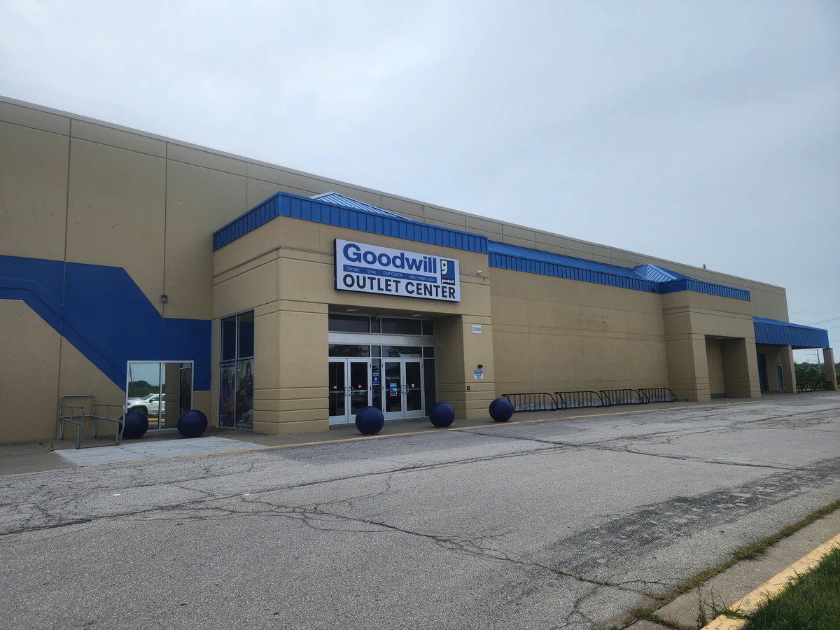 Goodwill Outlet & Recycling Center in Kansas City, Missouri, showing blue rolling bins filled with discounted merchandise.