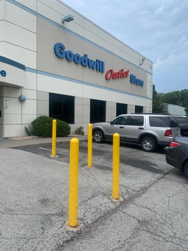 Goodwill Outlet & Recycling Center in Kansas City, Missouri, highlighting organized racks of clothing near the checkout area.