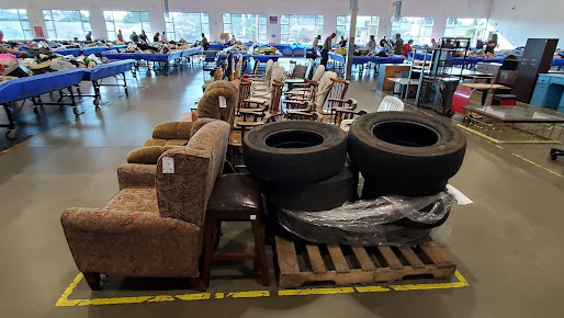 Goodwill Outlet Salem in Salem, Oregon, a Goodwill outlet store featuring shoppers searching through bulk textile containers.