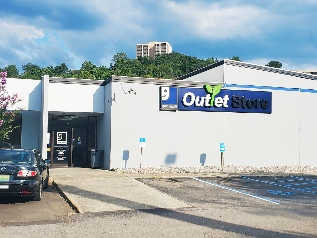 Goodwill Outlet Store in Birmingham, Alabama, showing blue rolling bins filled with discounted merchandise.