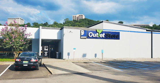 Goodwill Outlet Store in Birmingham, Alabama, displaying a large open layout with rows of donation bins.