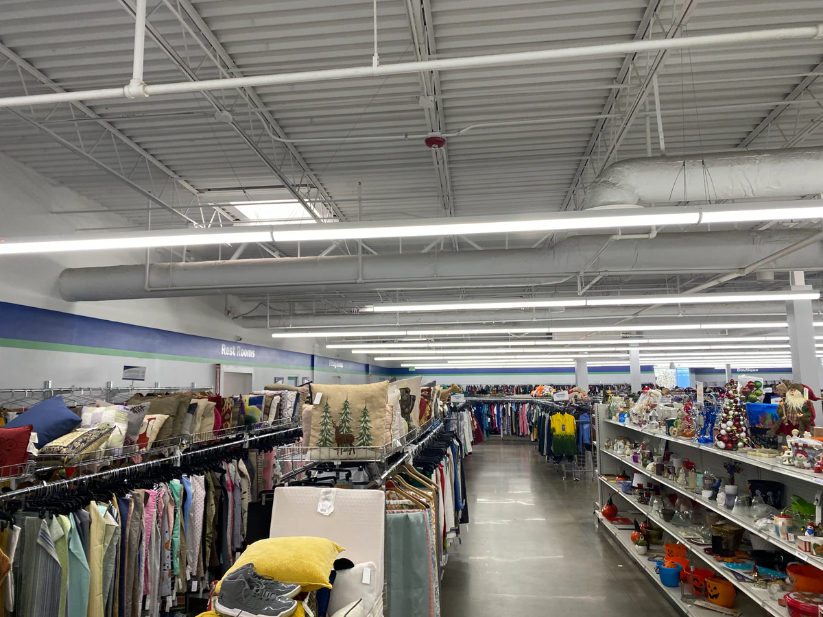 Goodwill Outlet Store in Birmingham, Alabama, featuring shoppers searching through bulk textile containers.