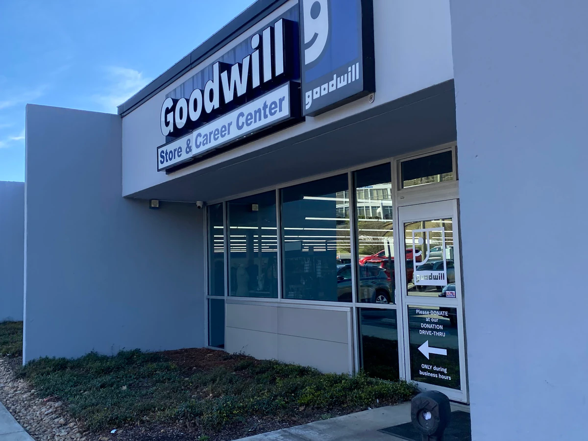 Goodwill Outlet Store in Birmingham, Alabama, highlighting organized racks of clothing near the checkout area.