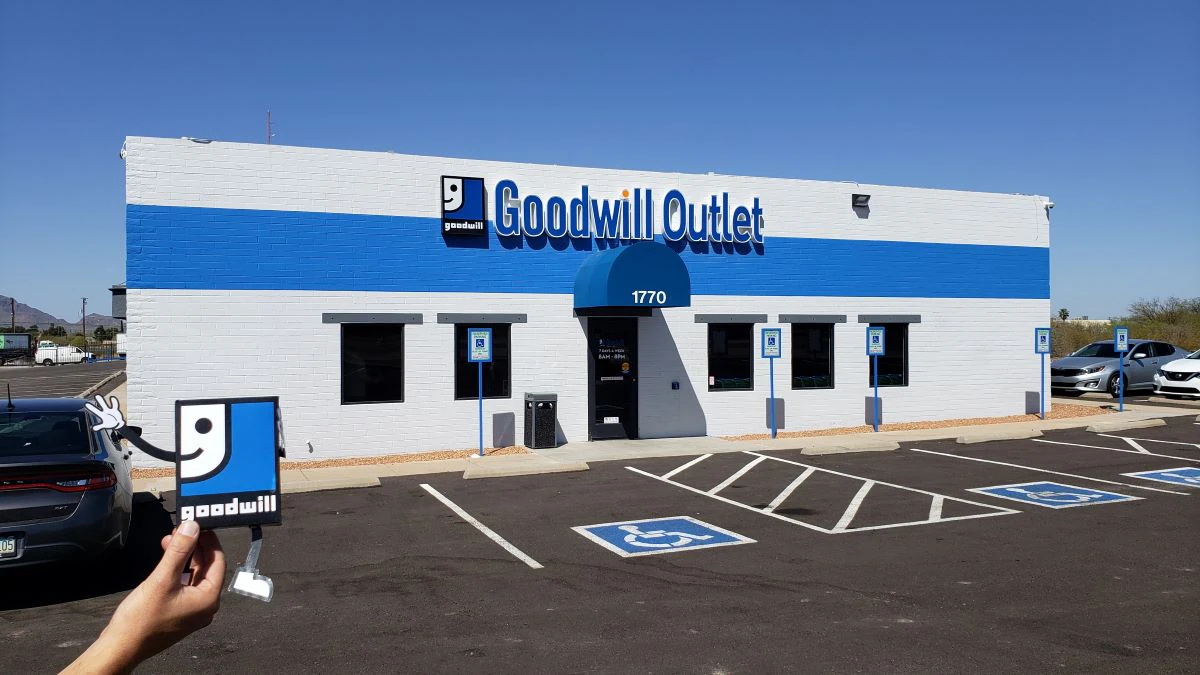 Goodwill Outlet Store and Donation Center in Nogales, Arizona, showing blue rolling bins filled with discounted merchandise.
