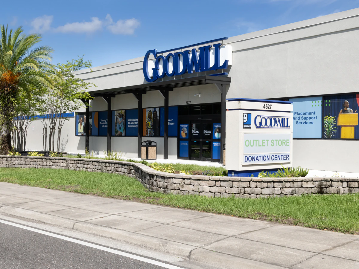 Goodwill Outlet Store and Donation Center, a Goodwill outlet store showing blue rolling bins filled with discounted merchand.