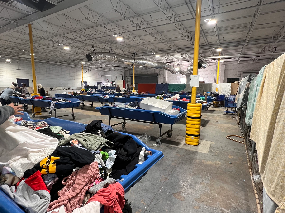 Goodwill Outlet Store and Donation Center, a Goodwill outlet store featuring shoppers searching through bulk textile contain.