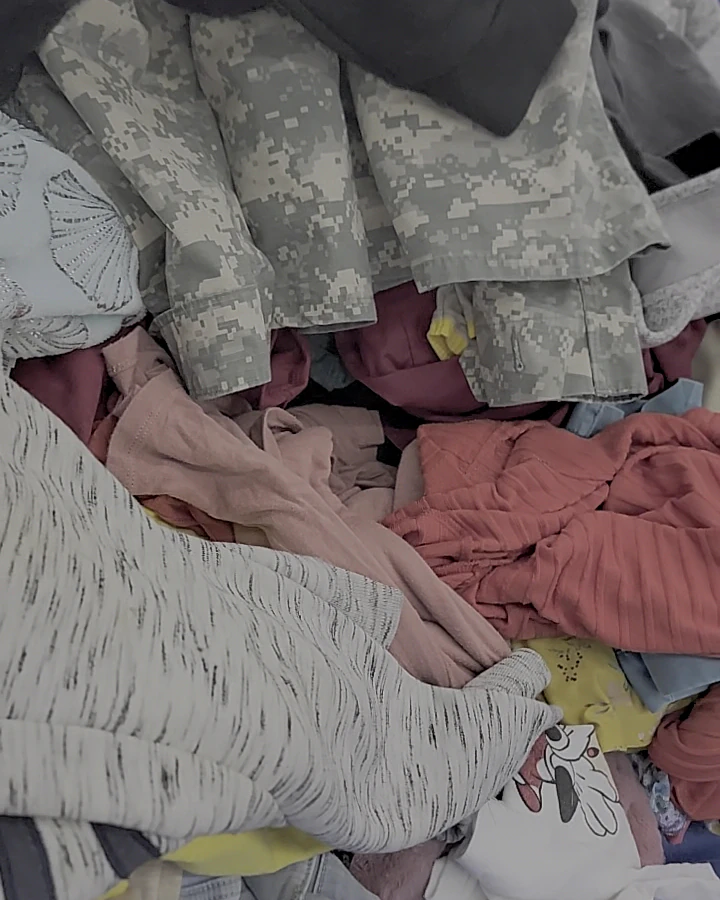 Goodwill Outlet Store and Donation Center, a Goodwill outlet store featuring shoppers searching through bulk textile contain.