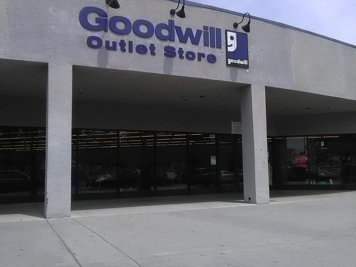Goodwill Outlet Store in San Bernardino, California, showing blue rolling bins filled with discounted merchandise.