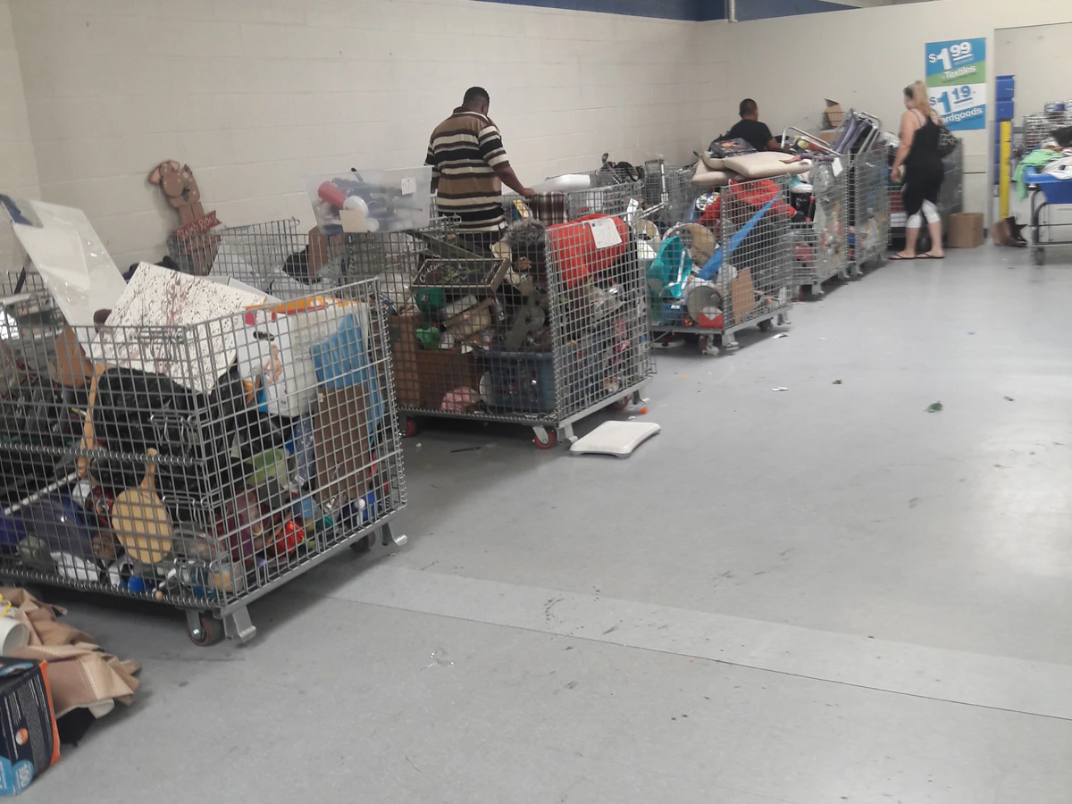 Goodwill Outlet Store in San Bernardino, California, featuring shoppers searching through bulk textile containers.