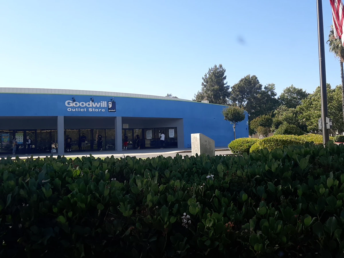 Goodwill Outlet Store in San Bernardino, California, showing the donation entrance and bulk pricing signage.
