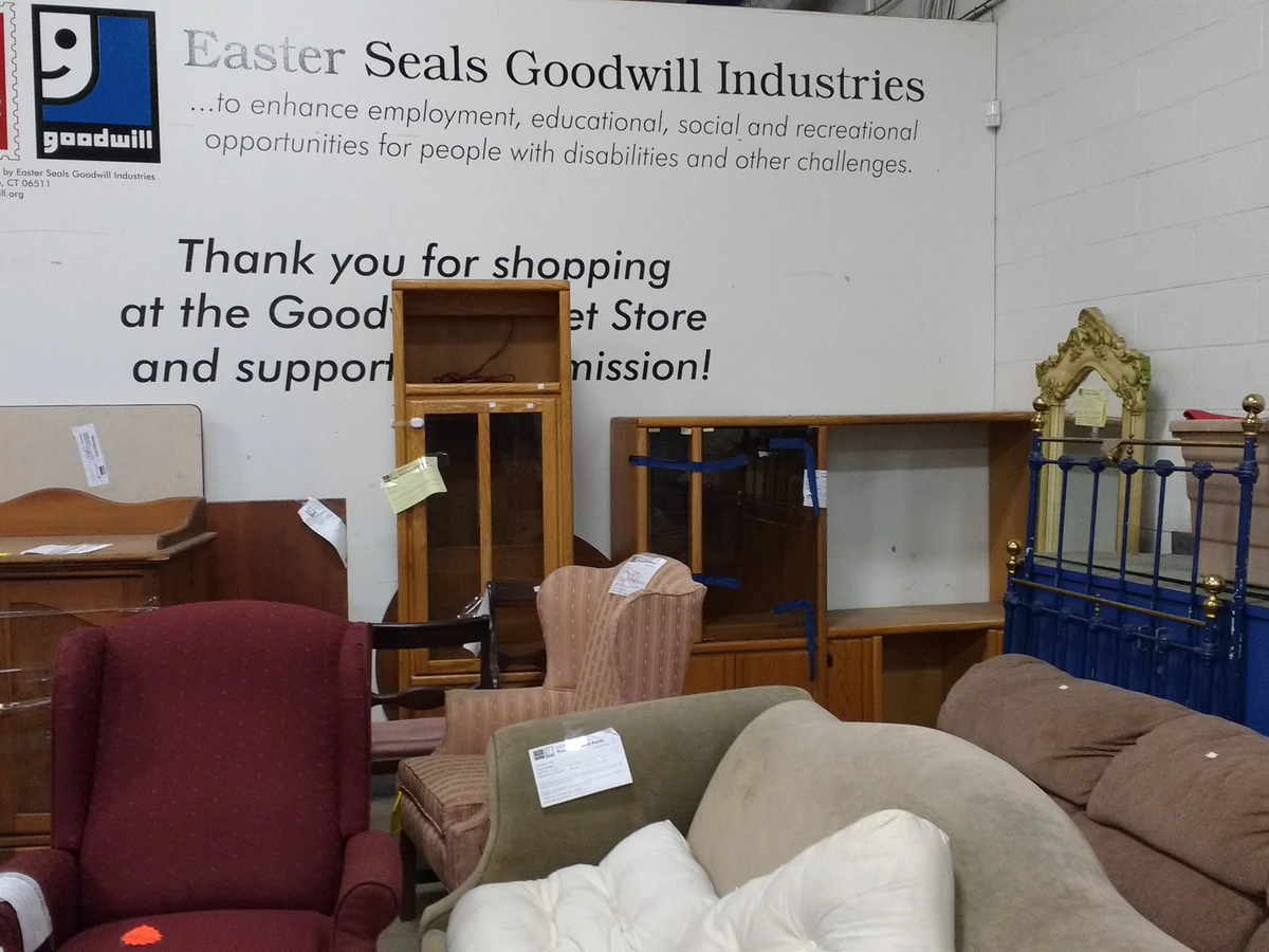 Goodwill Outlet Store in Hamden, Connecticut, featuring shoppers searching through bulk textile containers.
