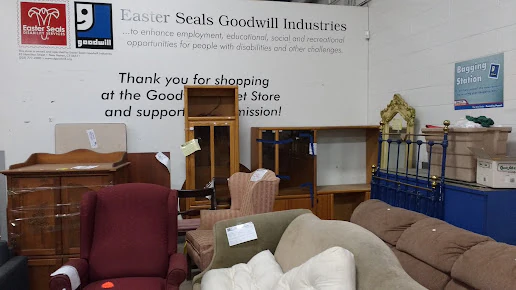 Goodwill Outlet Store in Hamden, Connecticut, highlighting organized racks of clothing near the checkout area.