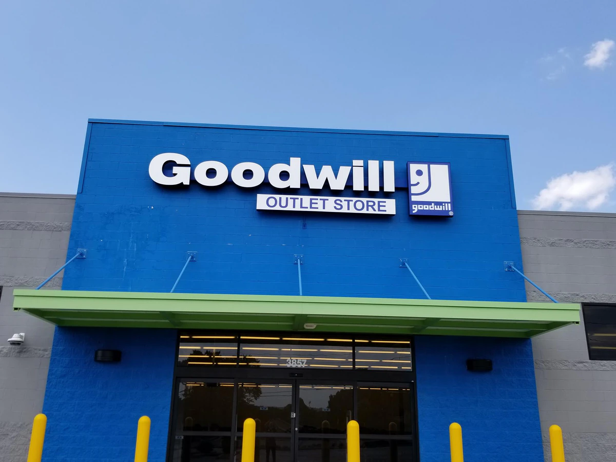 Goodwill Outlet Store in Columbus, Georgia, showing blue rolling bins filled with discounted merchandise.
