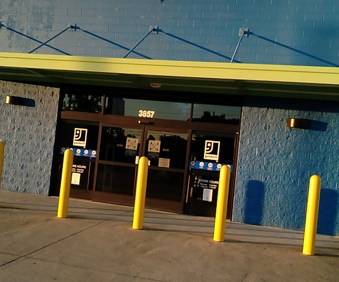 Goodwill Outlet Store in Columbus, Georgia, highlighting organized racks of clothing near the checkout area.