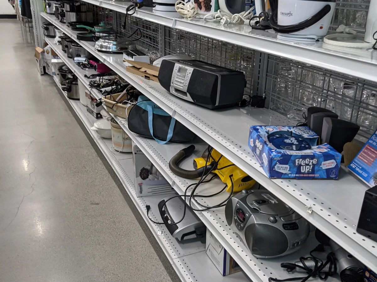Goodwill Outlet Store in Honolulu, Hawaii, featuring shoppers searching through bulk textile containers.