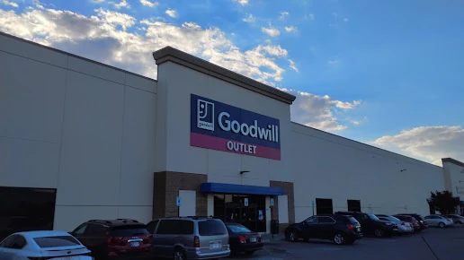 Goodwill Outlet Store in Indianapolis, Indiana, displaying a large open layout with rows of donation bins.