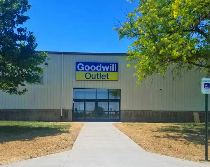 Goodwill Outlet Store in Cedar Rapids, Iowa, showing blue rolling bins filled with discounted merchandise.