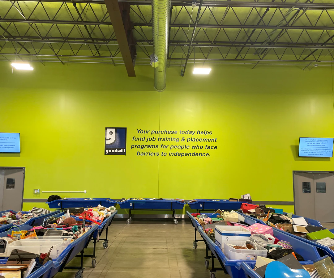 Goodwill Outlet Store in Cedar Rapids, Iowa, highlighting organized racks of clothing near the checkout area.