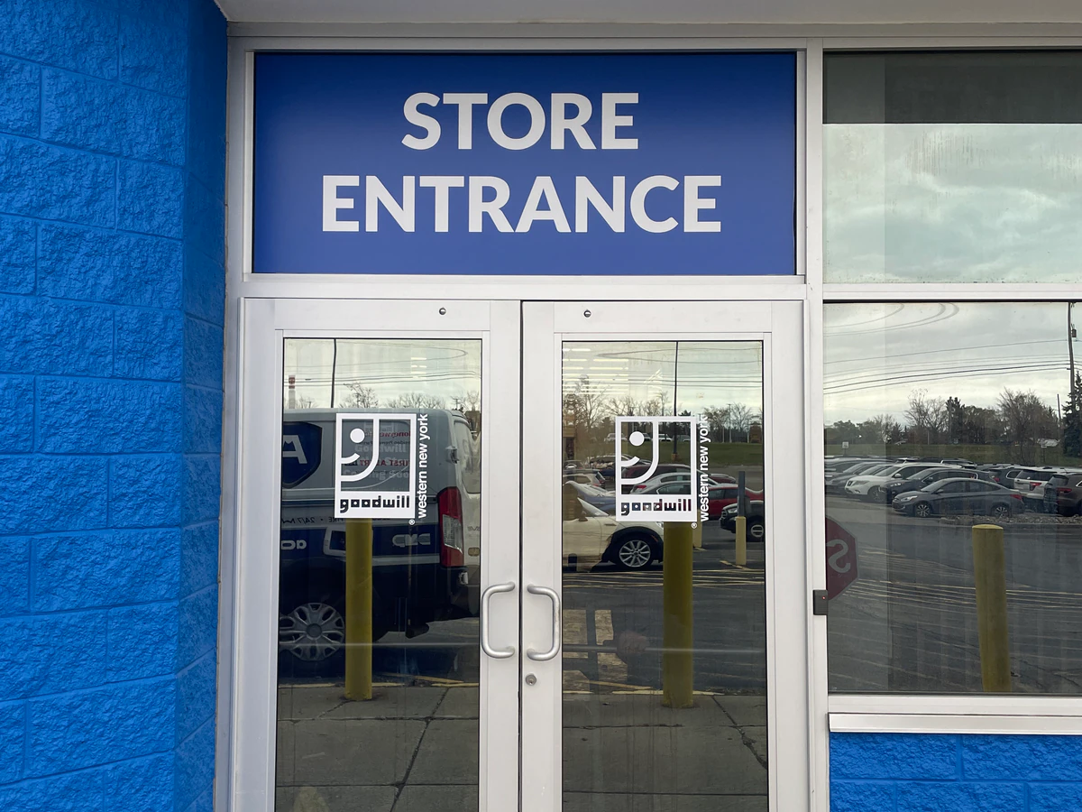 Goodwill Outlet Store in Hamburg, New-york, featuring shoppers searching through bulk textile containers.