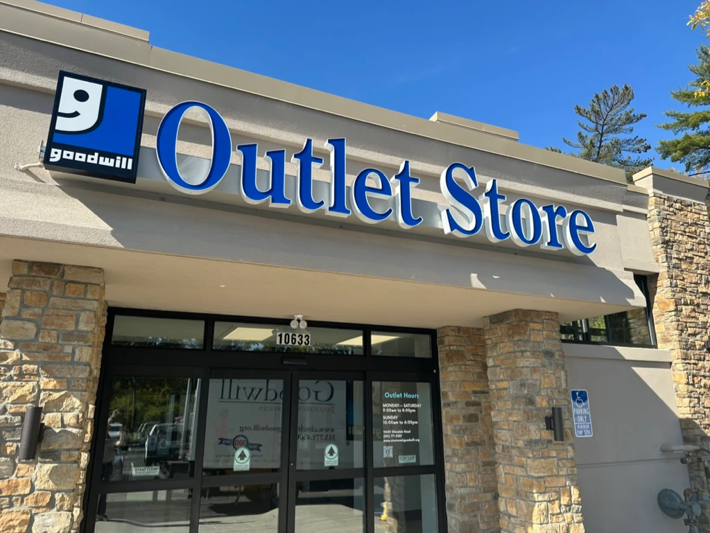 Goodwill Outlet Store in Cincinnati, Ohio, showing blue rolling bins filled with discounted merchandise.