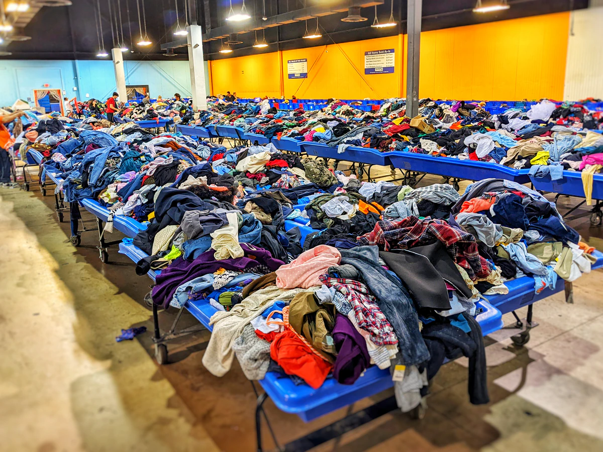 Goodwill Outlet Store in Oklahoma City, Oklahoma, featuring shoppers searching through bulk textile containers.