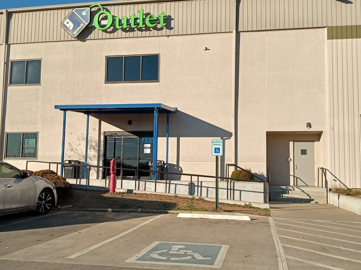 Goodwill Outlet Store in Berry Hill, Tennessee, showing blue rolling bins filled with discounted merchandise.