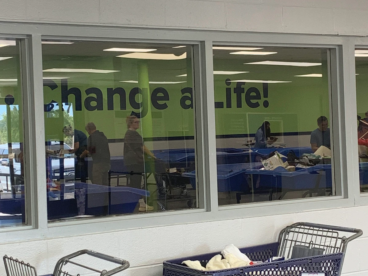 Goodwill Outlet Store in Berry Hill, Tennessee, featuring shoppers searching through bulk textile containers.
