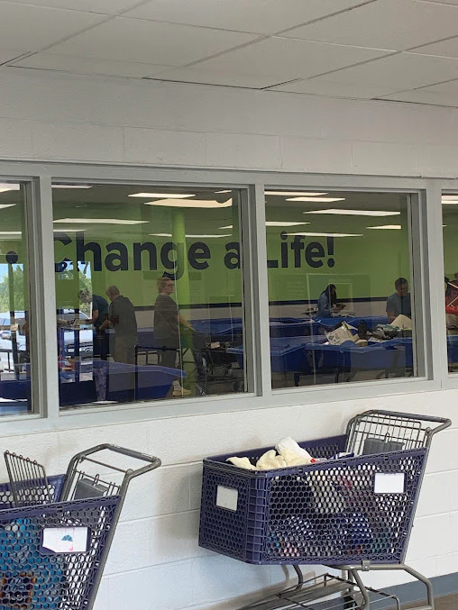 Goodwill Outlet Store in Berry Hill, Tennessee, highlighting organized racks of clothing near the checkout area.