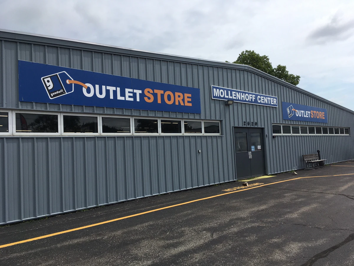 Goodwill Outlet Store Waterloo in Waterloo, Iowa, featuring shoppers searching through bulk textile containers.