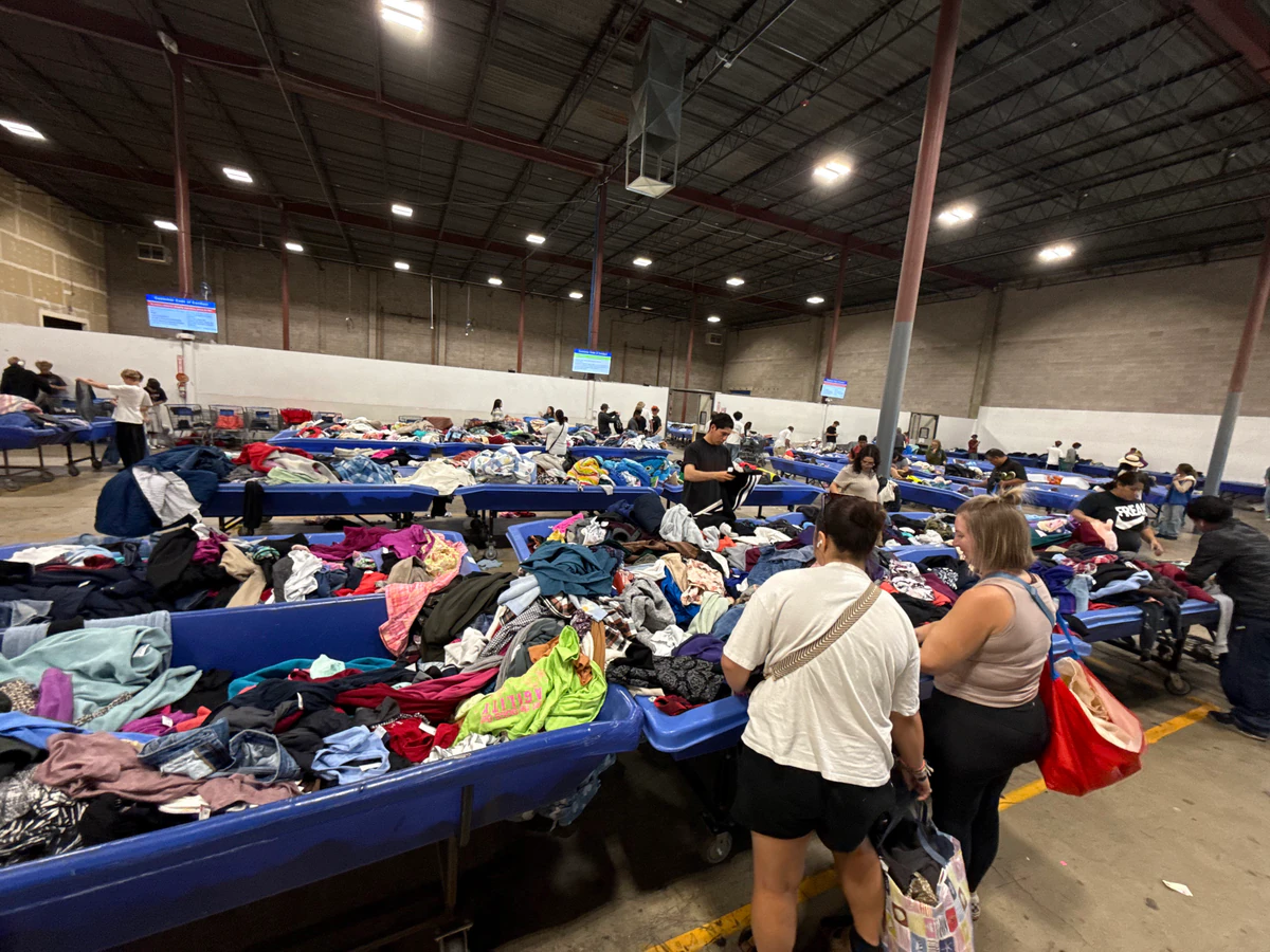 Goodwill Outlet in Salt Lake City, Utah, featuring shoppers searching through bulk textile containers.