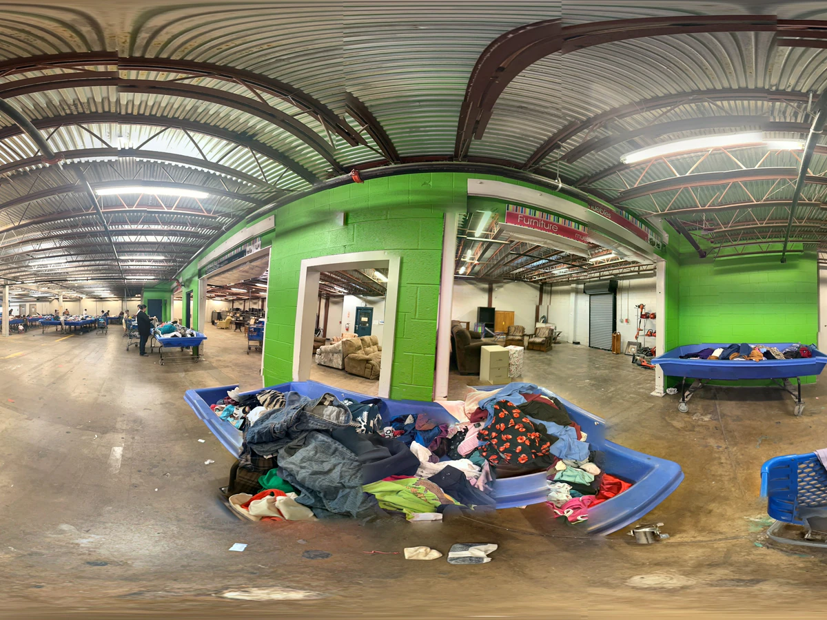 Goodwill Outlet Waco in Waco, Texas, a Goodwill outlet store featuring shoppers searching through bulk textile containers.