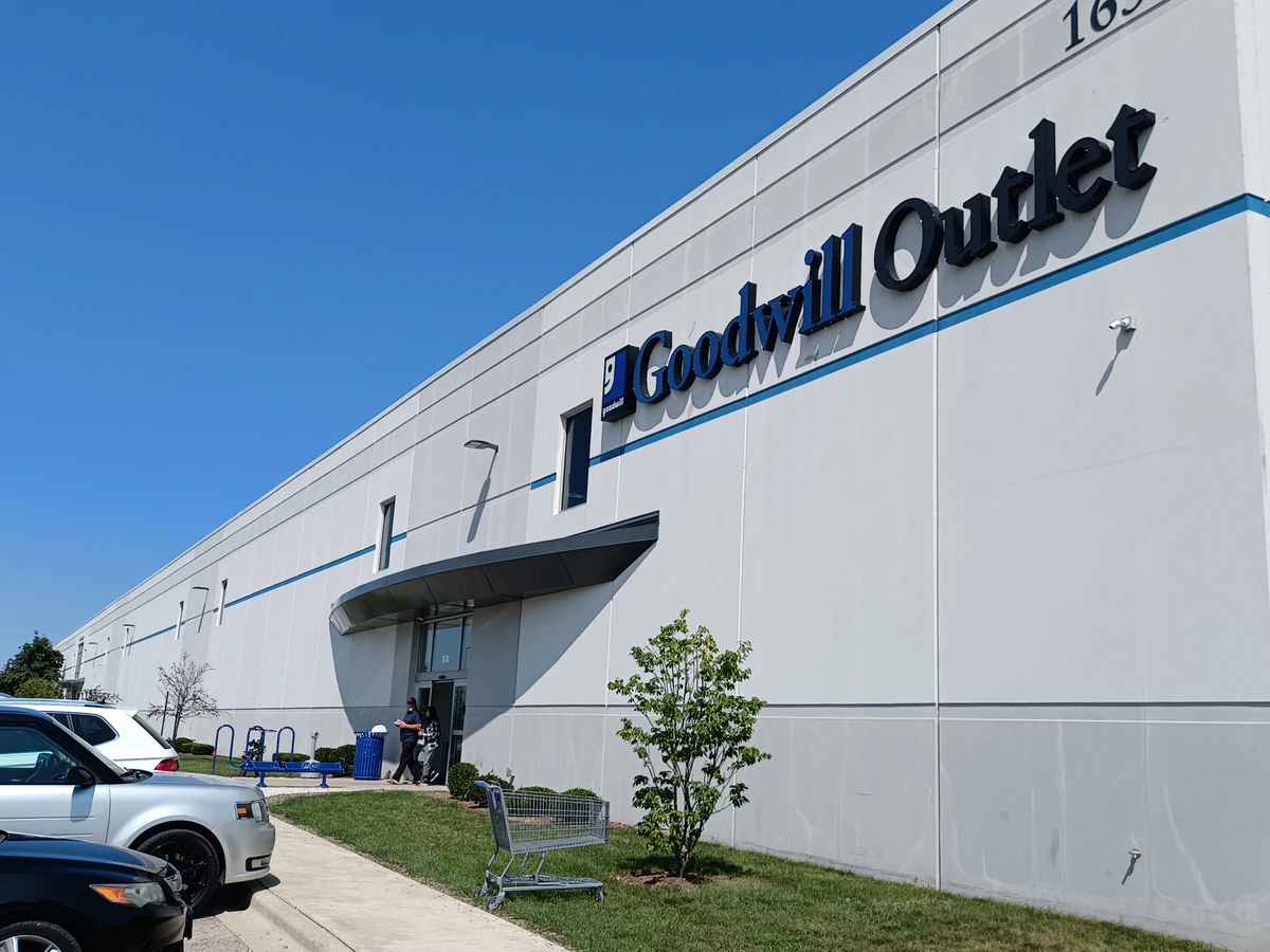 Goodwill Outlet in Milwaukee, Wisconsin, showing blue rolling bins filled with discounted merchandise.
