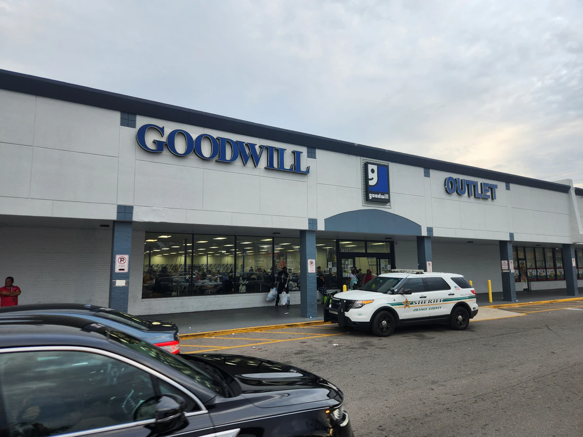 Goodwill - Pine Hills Outlet in Orlando, Florida, showing blue rolling bins filled with discounted merchandise.
