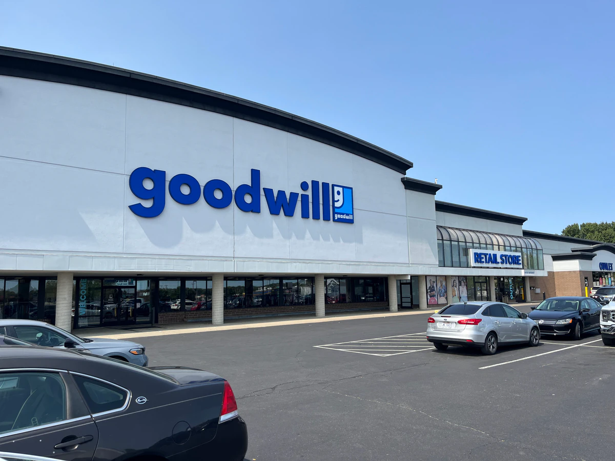 Goodwill Retail Store, Outlet & Donation Center, a Goodwill outlet store showing blue rolling bins filled with discounted me.