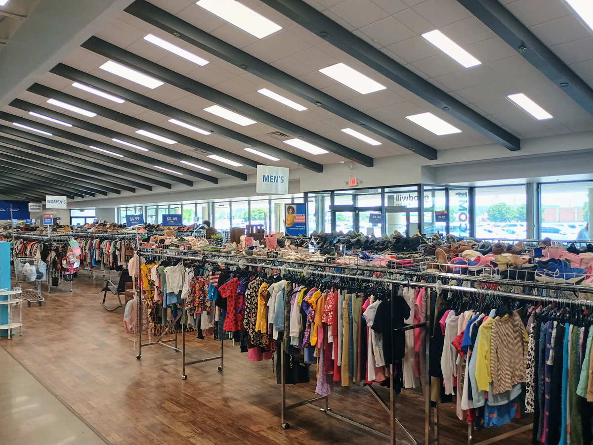 Goodwill Retail Store, Outlet & Donation Center, a Goodwill outlet store featuring shoppers searching through bulk textile c.