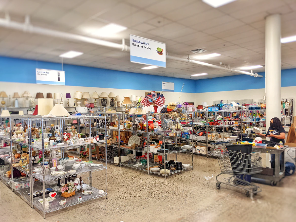 Goodwill- San Mateo in Albuquerque, New-mexico, showing rows of affordable footwear and accessories for sale.