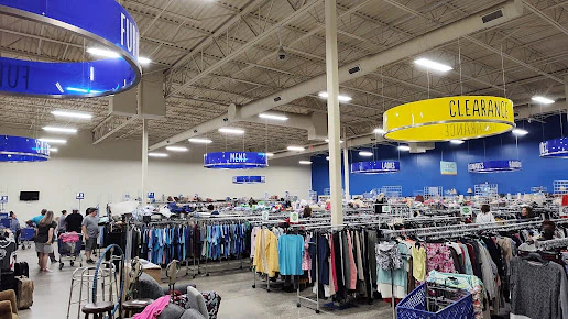 Goodwill in West Columbia, South-carolina, showing rows of affordable footwear and accessories for sale.