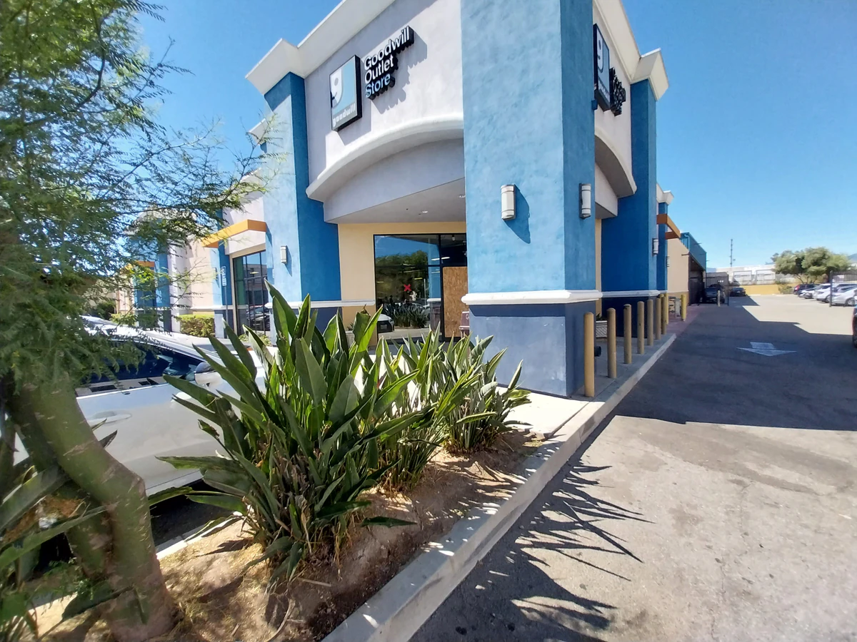 Goodwill Southern California Outlet Store, a Goodwill outlet store highlighting organized racks of clothing near the checkou.