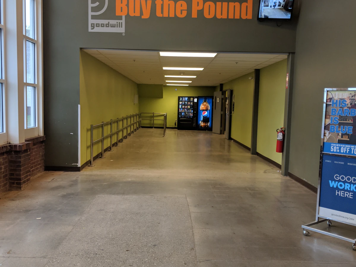 Goodwill Store and Buy the Pound Outlet, a Goodwill outlet store showing blue rolling bins filled with discounted merchandis.