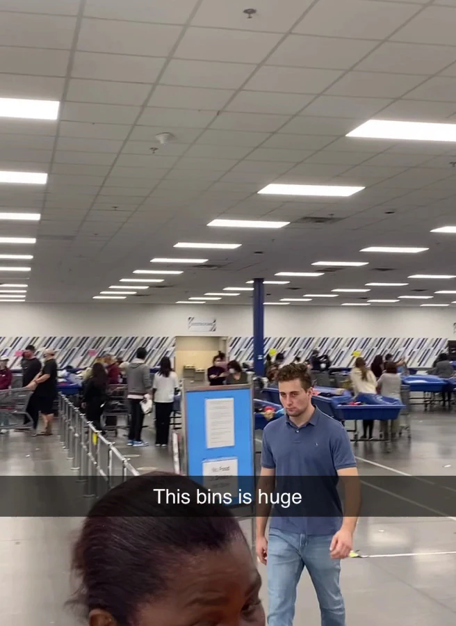 Goodwill - Taft Outlet in Orlando, Florida, featuring shoppers searching through bulk textile containers.