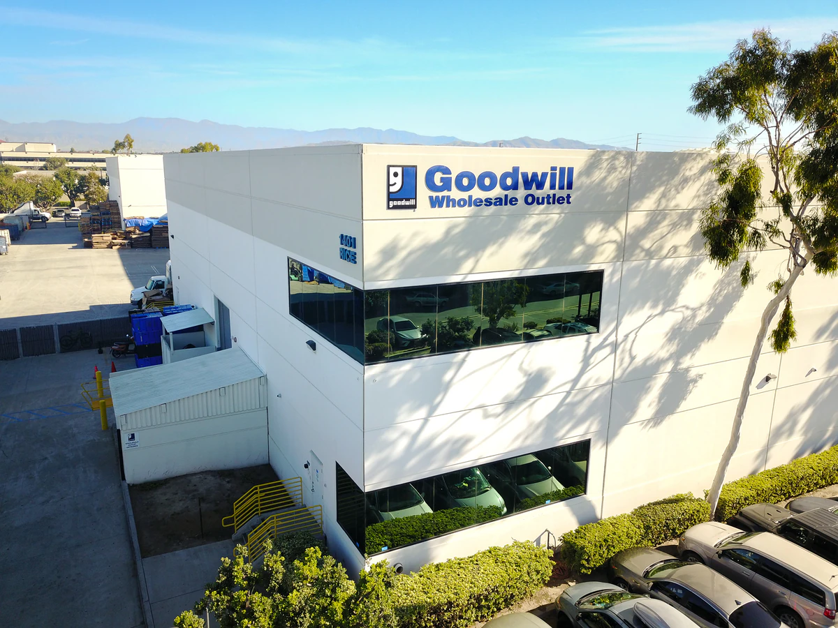 Goodwill Wholesale Outlet in Oxnard, California, displaying a large open layout with rows of donation bins.